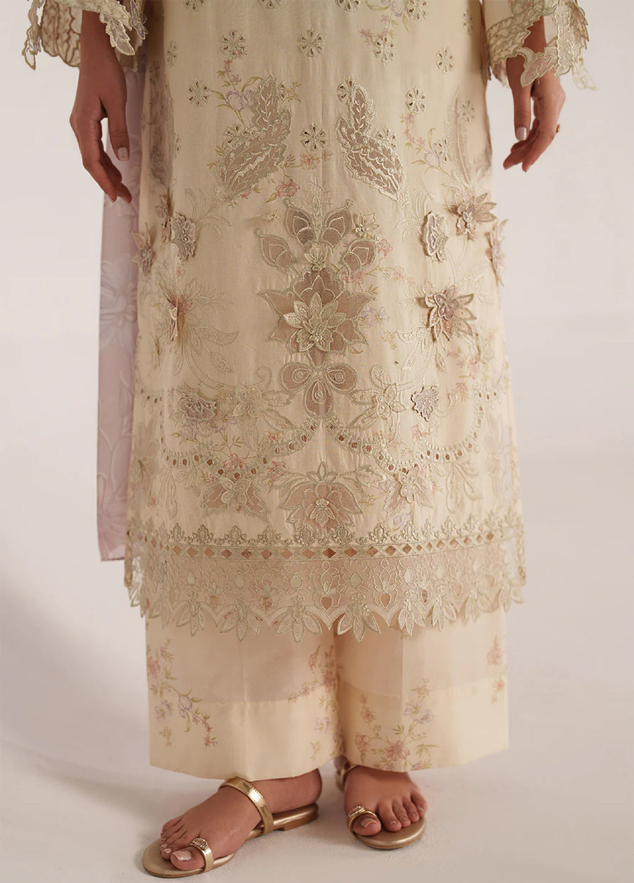 Detailed view of the sleeve embroidery with scalloped lace cuffs on the cream lawn suit