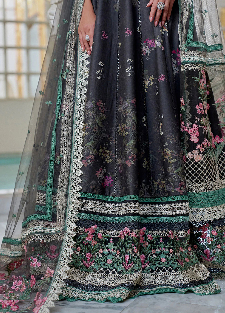 Close-up of the bottom hem of the lawn suit displaying layered lace trims and rich floral embroidery detailing.
