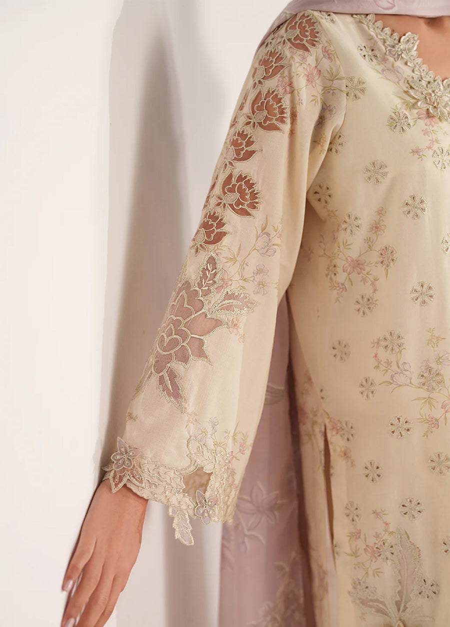 Close-up of the front embroidery showcasing floral motifs on the cream lawn fabric