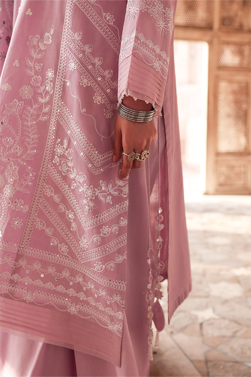 Side view showcasing embroidery and side slit with tassel detailing on pastel pink lawn shirt