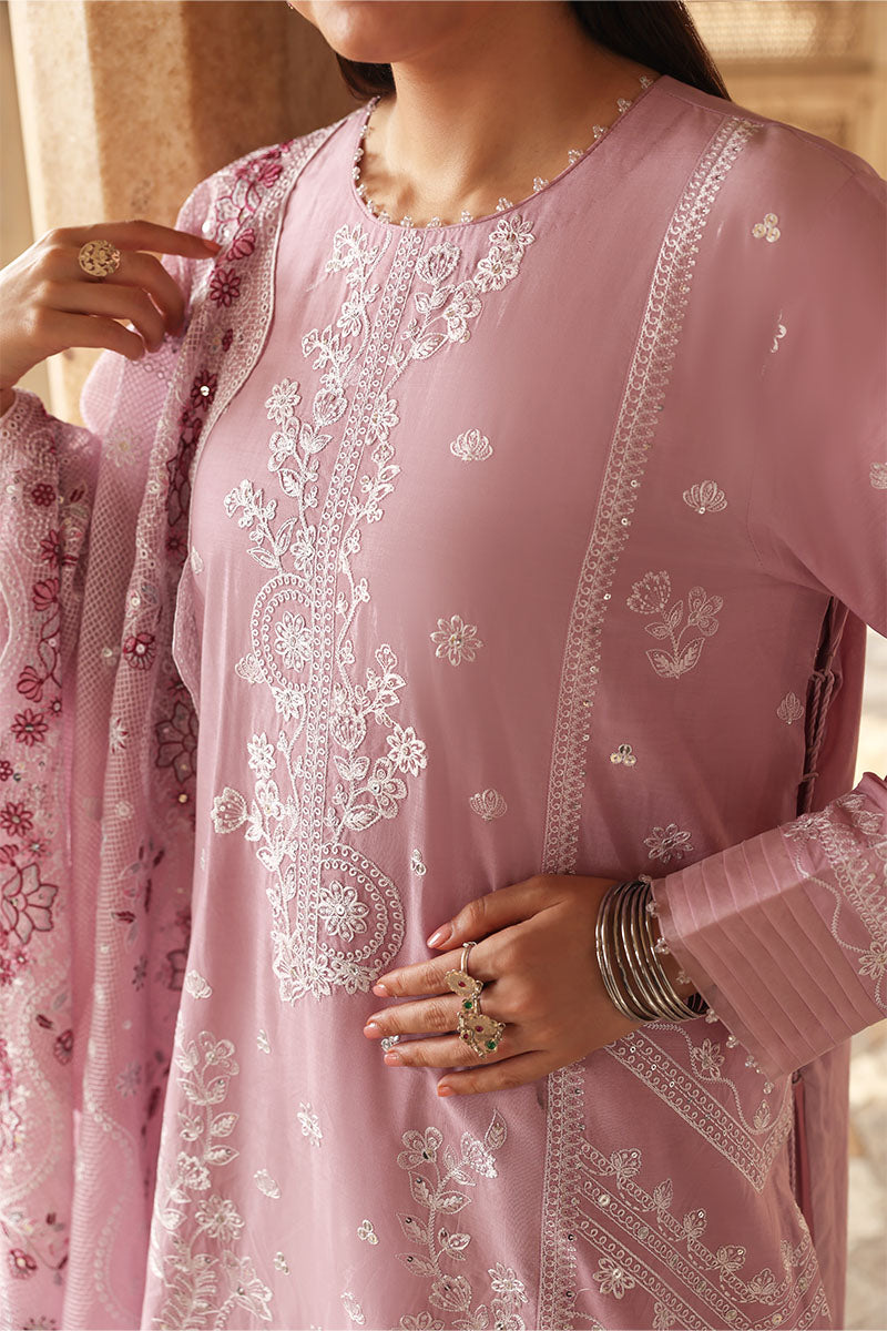 Close-up of white floral embroidery on the neckline and front of the pastel pink lawn shirt