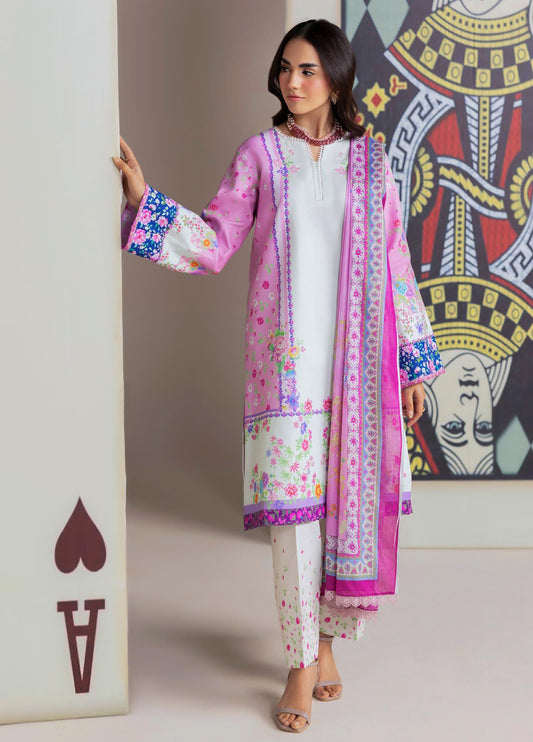 Woman wearing an elegant pink and white floral printed lawn suit with digital prints and matching dupatta, posing near a large Ace of Spades card.