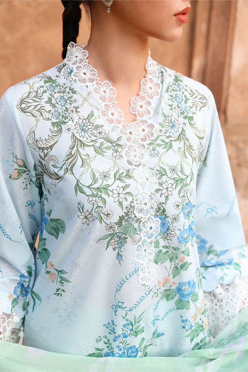 Close-up view of the floral embroidered lawn suit showcasing white lace embroidery on the neckline and the intricate floral pattern in blue and green tones.