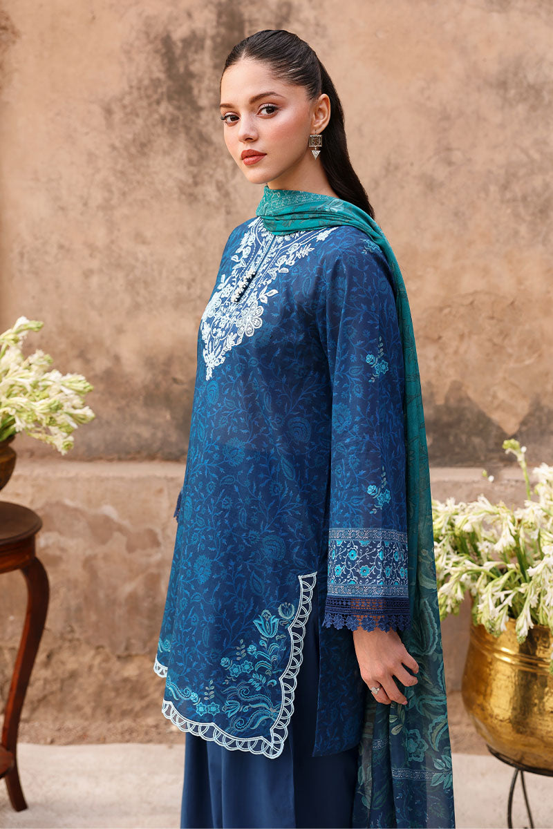 Side profile of woman wearing navy blue embroidered lawn suit and teal dupatta showcasing sleeve and dupatta design