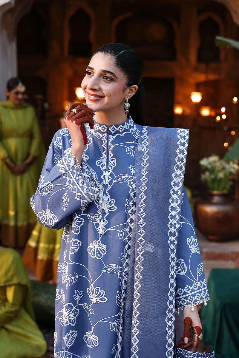 Close-up of the upper half showing embroidered front and sleeves of the blue lawn suit with detailed white floral embroidery