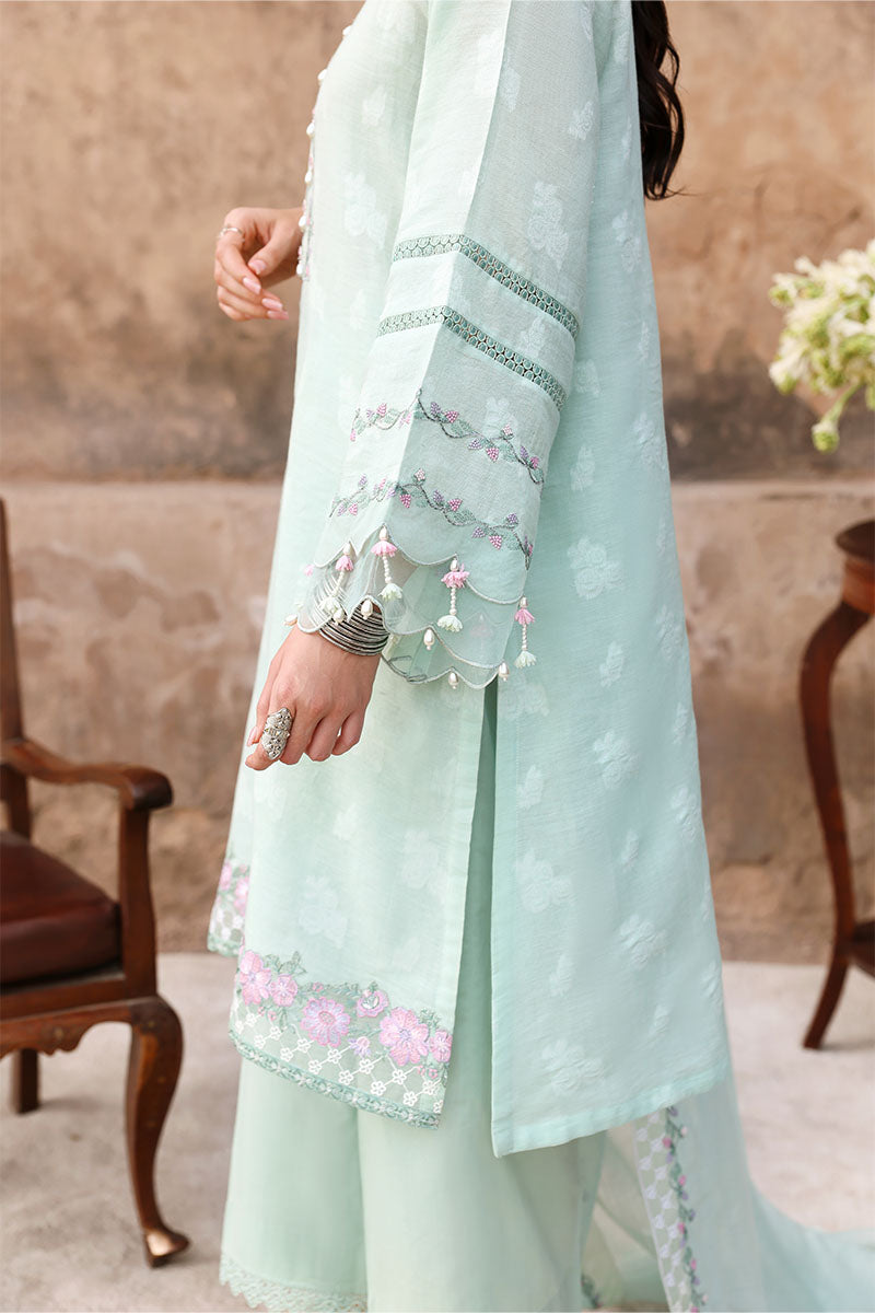 Close-up of lower half showing embroidered hem of kurta, lace-trimmed trousers, and matching embroidered dupatta