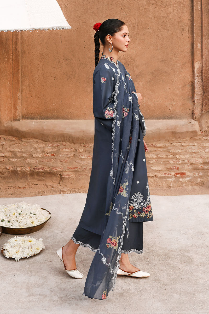 Side profile of woman showcasing the straight-cut long kameez and dupatta with embroidery, paired with matching straight pants