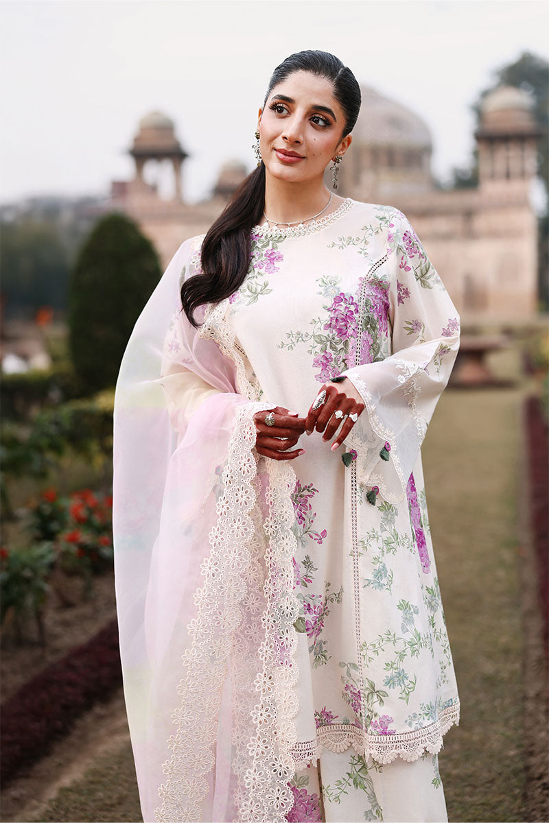 Close-up of woman in floral lawn suit showing intricate lace details on the neckline and delicate floral patterns, holding the sheer dupatta.