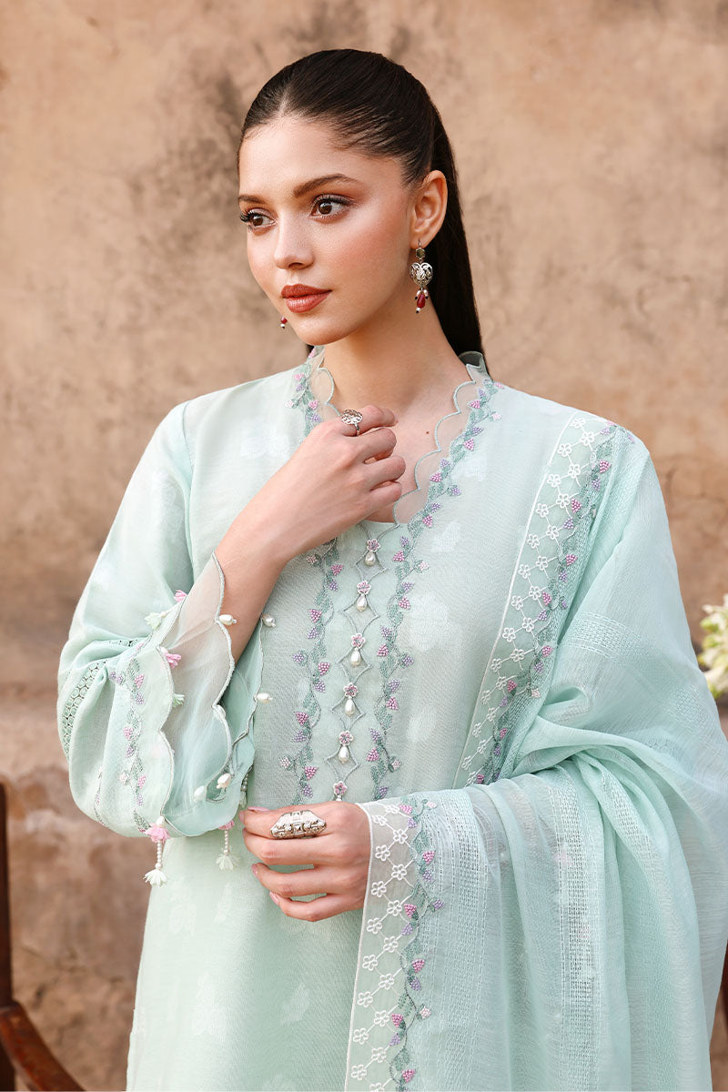 Model displaying front upper half of suit including embroidered sleeves and detailed dupatta
