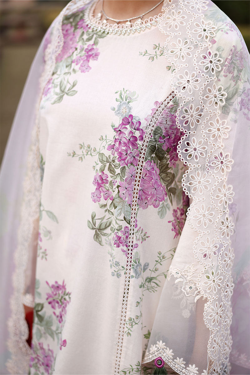 Detailed close-up of floral print on the cream fabric showcasing purple flowers and delicate lace embroidery along the suit edges.
