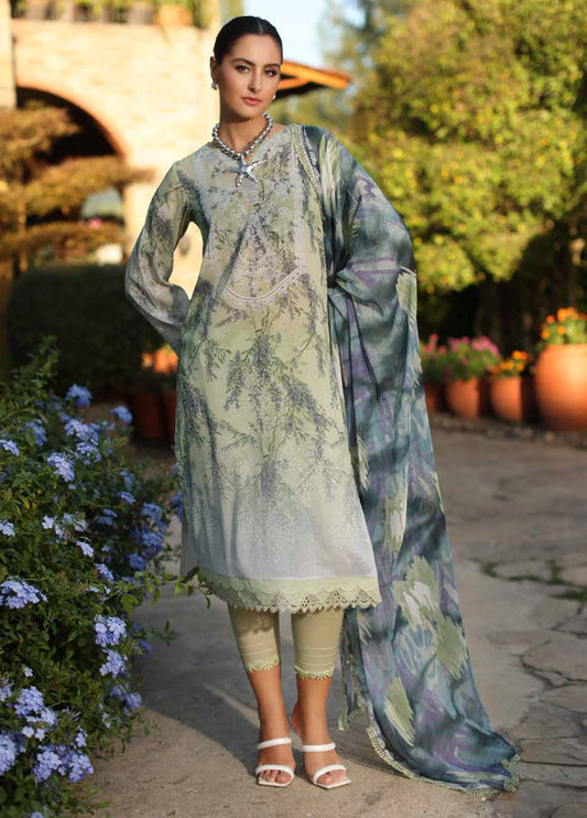 Woman wearing an embroidered Swiss lawn three-piece suit in soft green tones with printed chiffon dupatta, styled with white sandals.