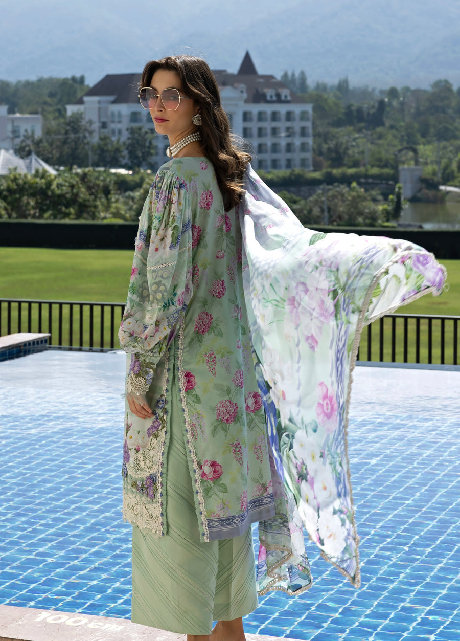 Rear view of woman in pastel green floral embroidered lawn suit showcasing back embroidery and sheer floral chiffon dupatta by the poolside