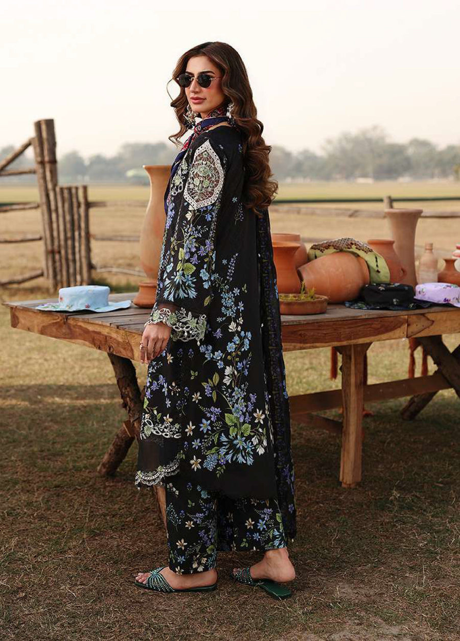 Side view of the black floral embroidered lawn suit showing intricate embroidery and digital prints on sleeves and trousers.