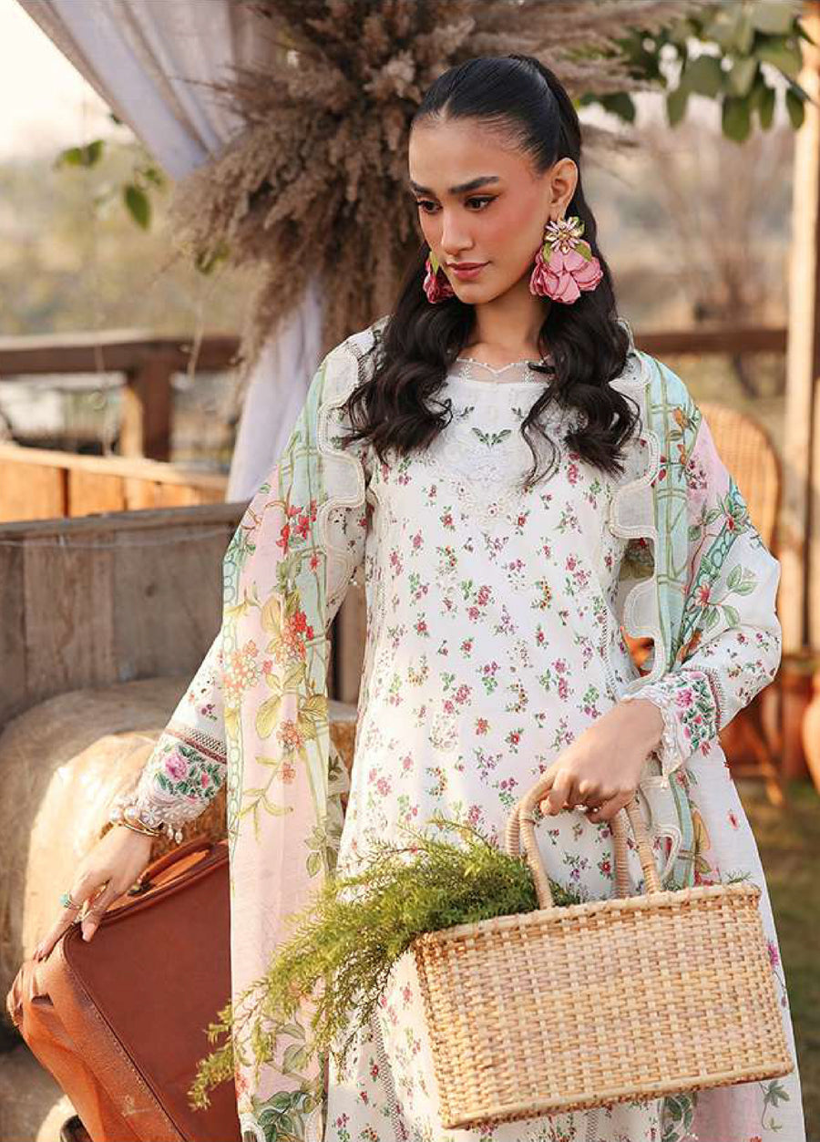 Close-up of woman holding woven handbag wearing white floral embroidered lawn suit with pink flower earrings and pastel floral dupatta