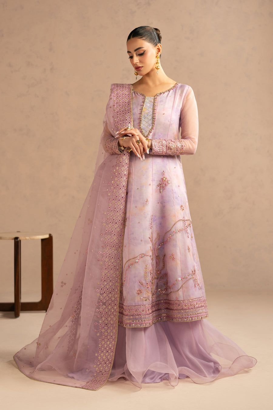 Close-up of embroidered neckline, detailed beadwork and sheer organza sleeves with embroidered cuffs on mauve frock