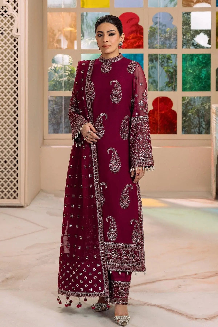Model posing with magenta embroidered traditional suit highlighting neckline and dupatta