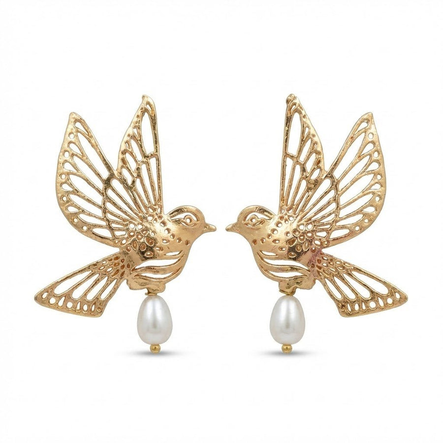 Pair of gold earrings shaped like birds in flight with detailed filigree wings and a white pearl drop hanging at the bottom