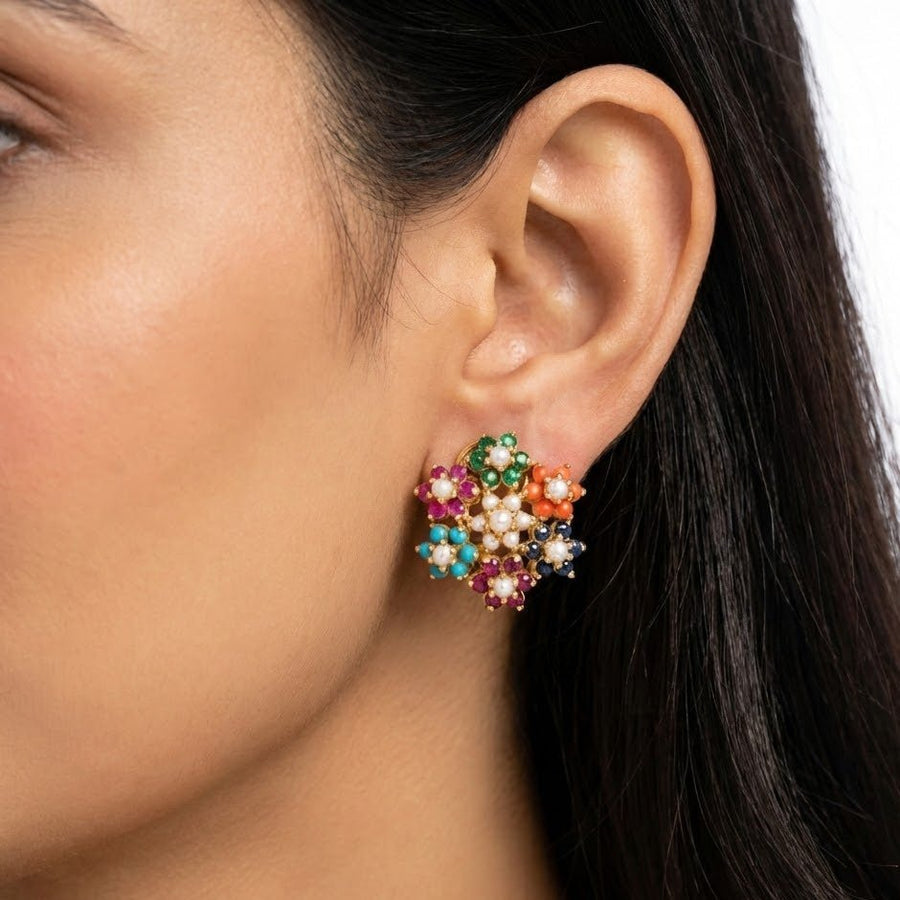 Model wearing multicolor floral cluster earrings showcasing how they sit on the ear