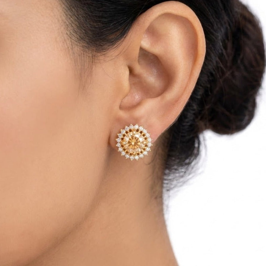 Woman wearing champagne gemstone halo stud earrings showcasing classic style