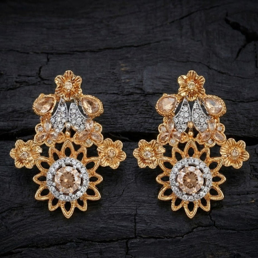 Champagne beige floral gemstone earrings displayed on dark textured surface with focused lighting