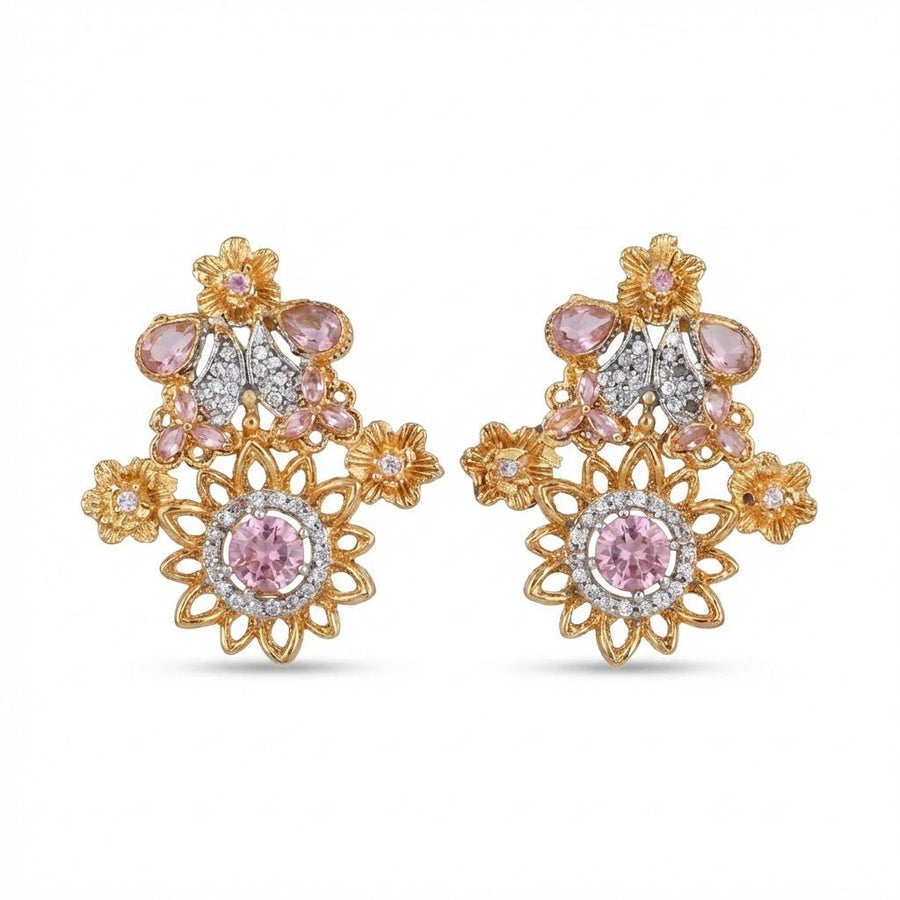 Soft pink gemstone floral earrings with sparkling accents on cream surface with warm lighting