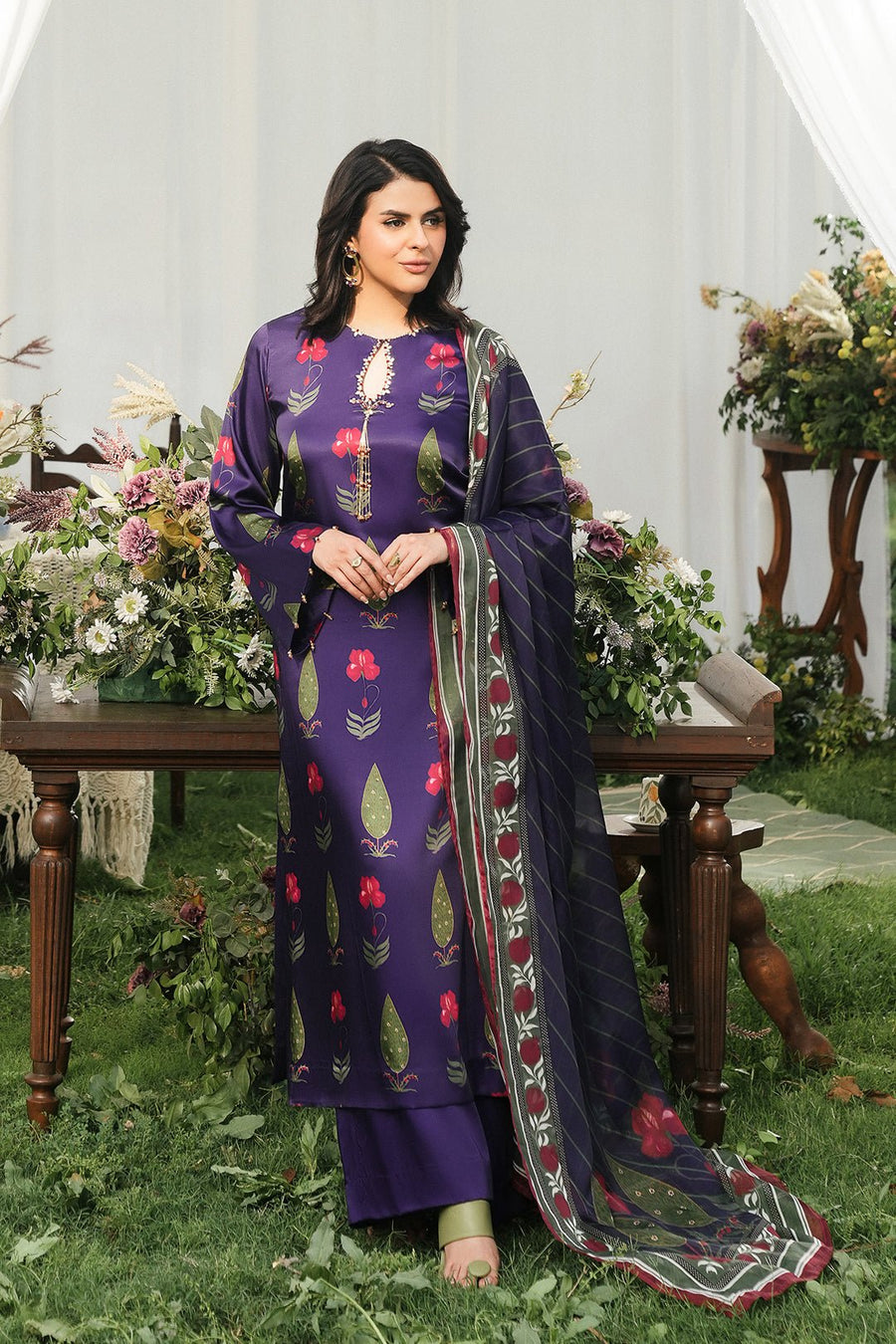 Full view of woman posing outdoors wearing the floral printed purple silk kurta with coordinating dupatta draped over shoulder