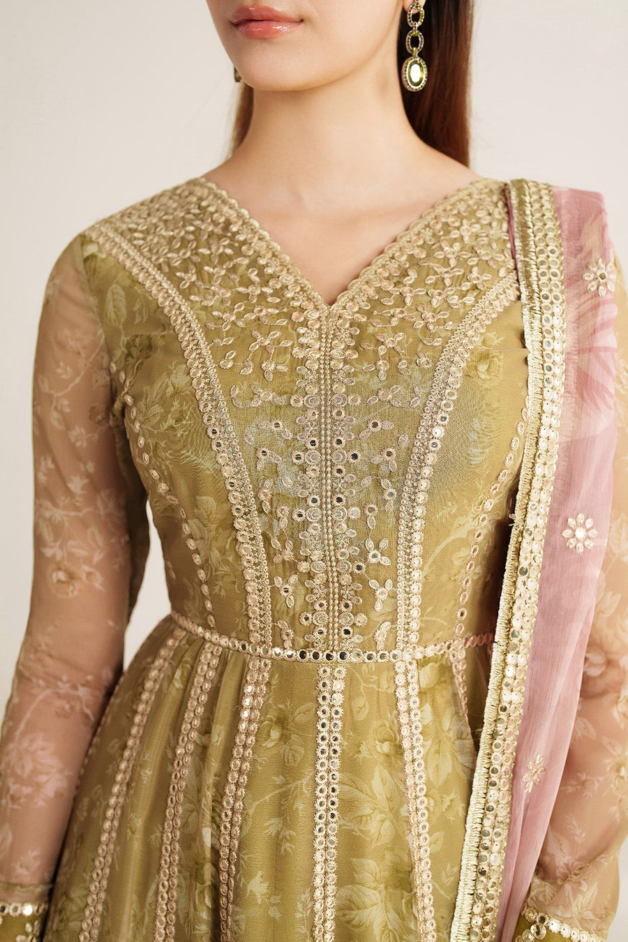 Close-up showing intricate embroidery and sequin work on sleeve cuff and bodice of olive green formal Anarkali dress