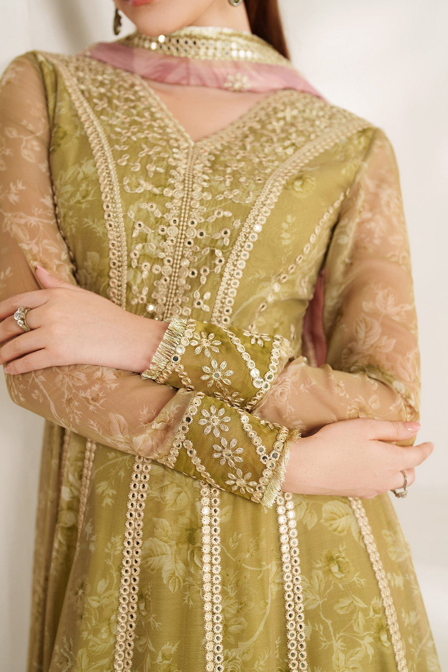 Detailed close-up of cuff embroidery and sequin embellishments on the sheer sleeve of olive green formal Anarkali