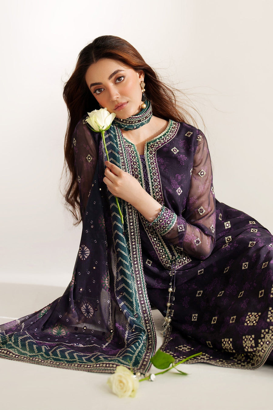 Detailed front view of embroidered suit fabric pattern focusing on geometric and floral motifs