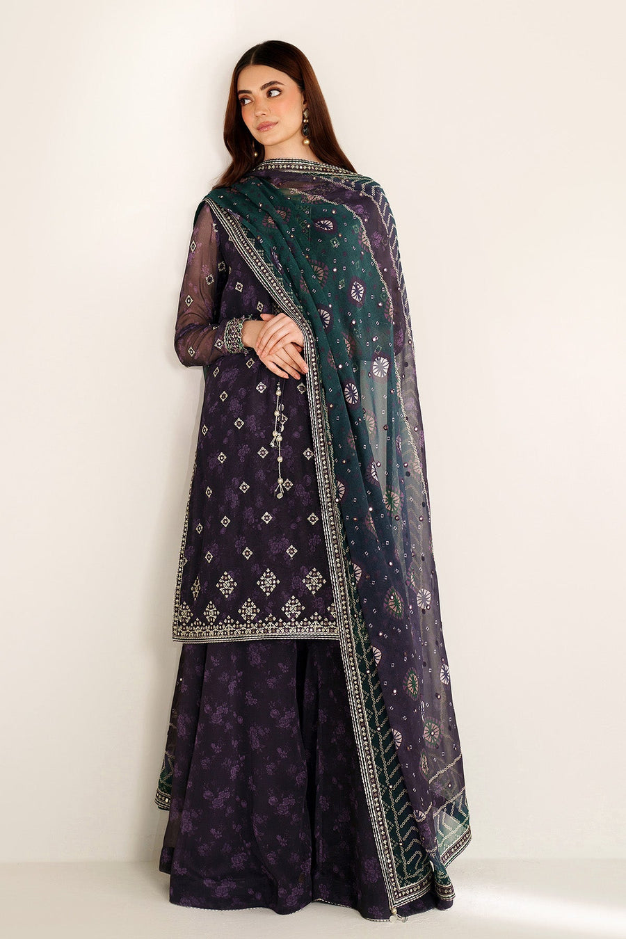 Woman wearing deep purple embroidered Pakistani formal suit with matching embroidered dupatta