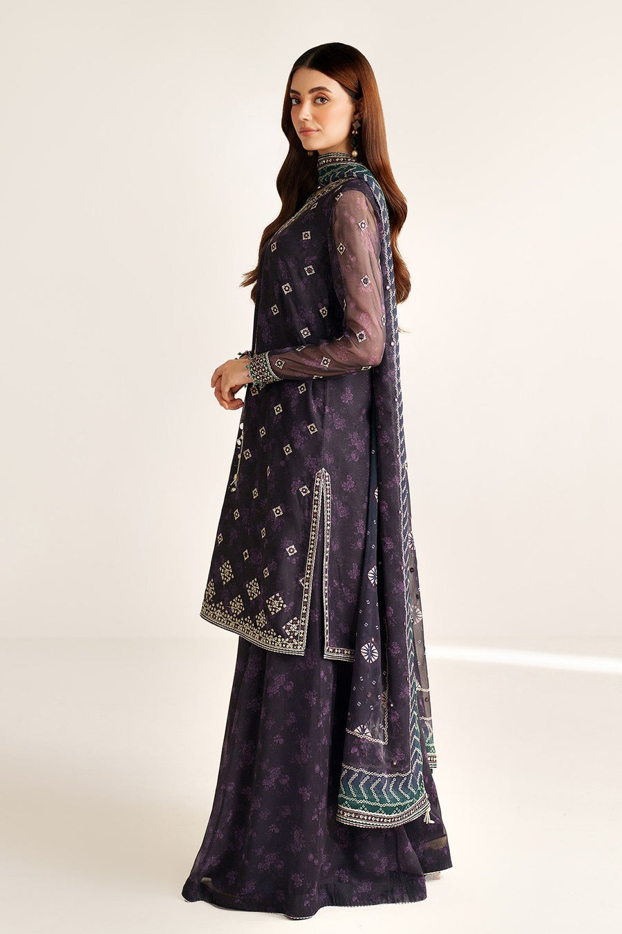 Side view of deep purple embroidered formal suit showing sheer sleeves and detailed embroidery
