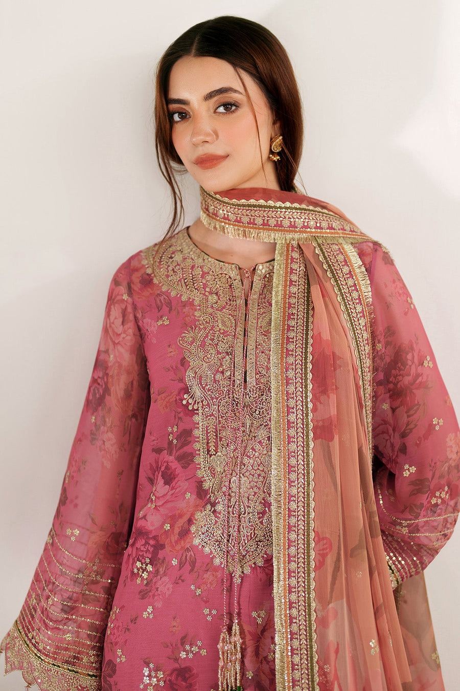Close-up front view highlighting intricate embroidery and side thread tassels of mauve-pink chiffon suit