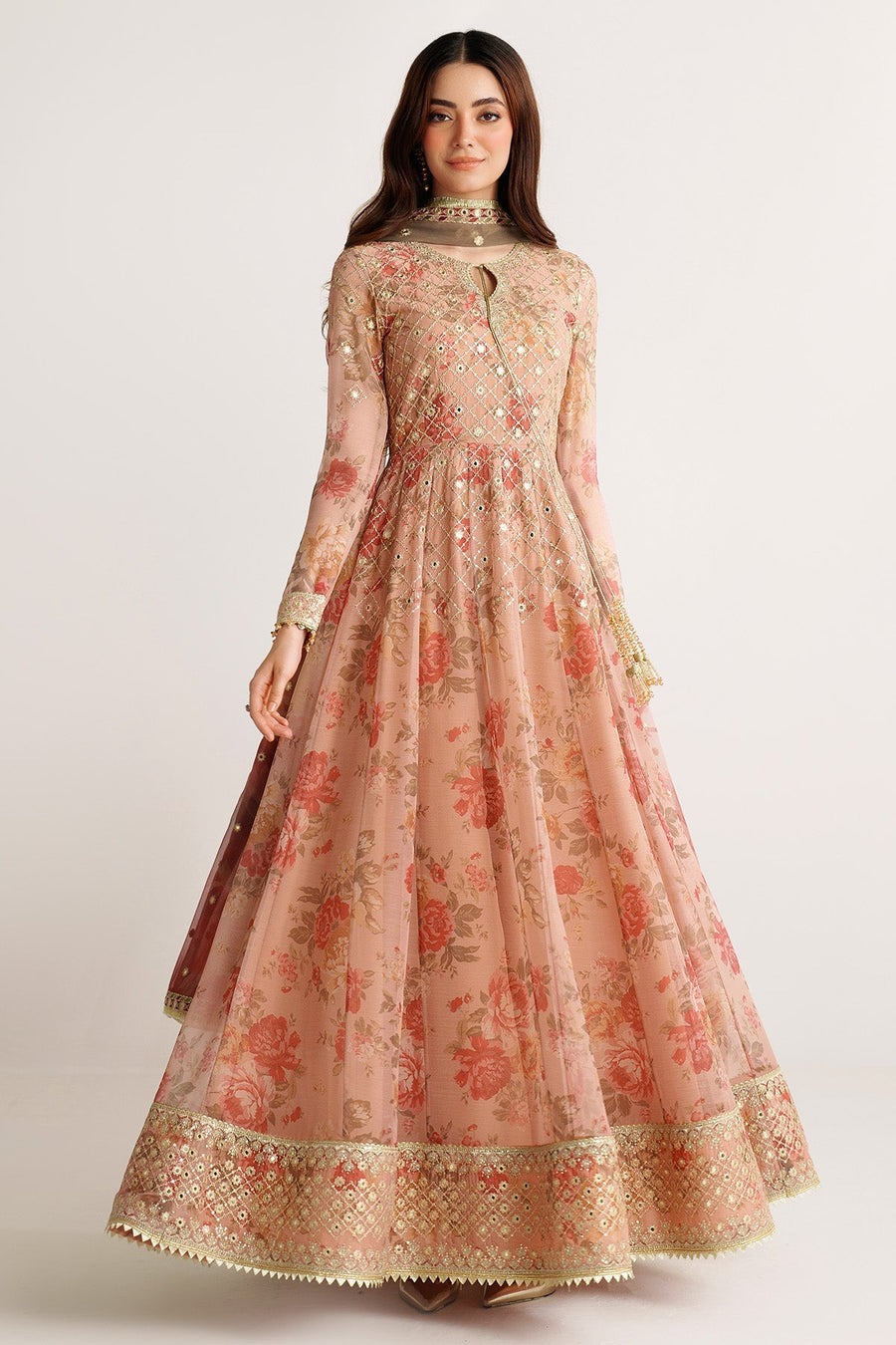 Full body front view of model showcasing peach floral embroidered chiffon Anarkali suit with gold detailed hems