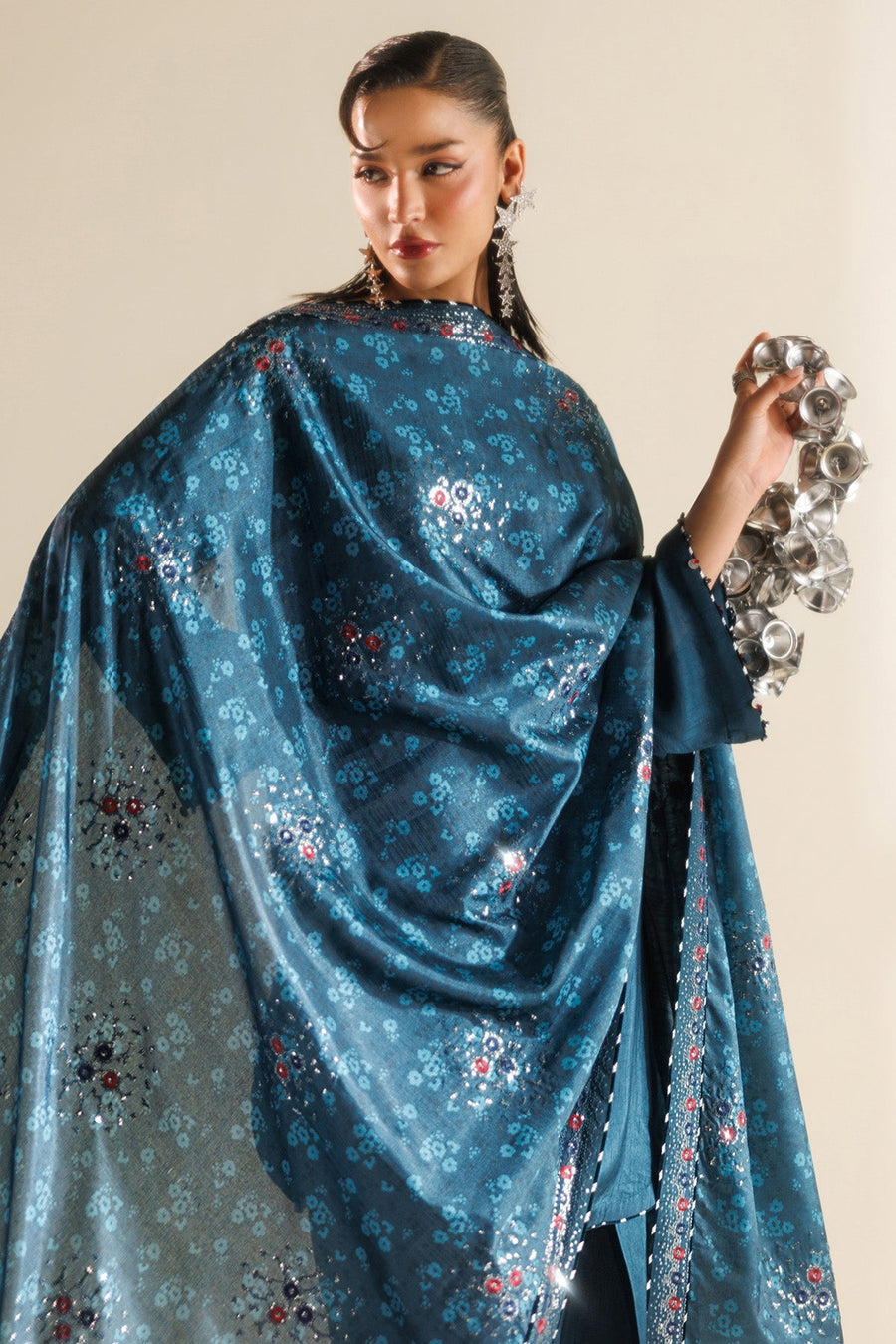Side close-up of decorative embroidery on neckline, featuring fine needlework and embellishments.