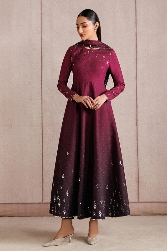 Front view of woman standing in embroidered deep magenta Anarkali suit with flowy skirt and matching dupatta draped on shoulders