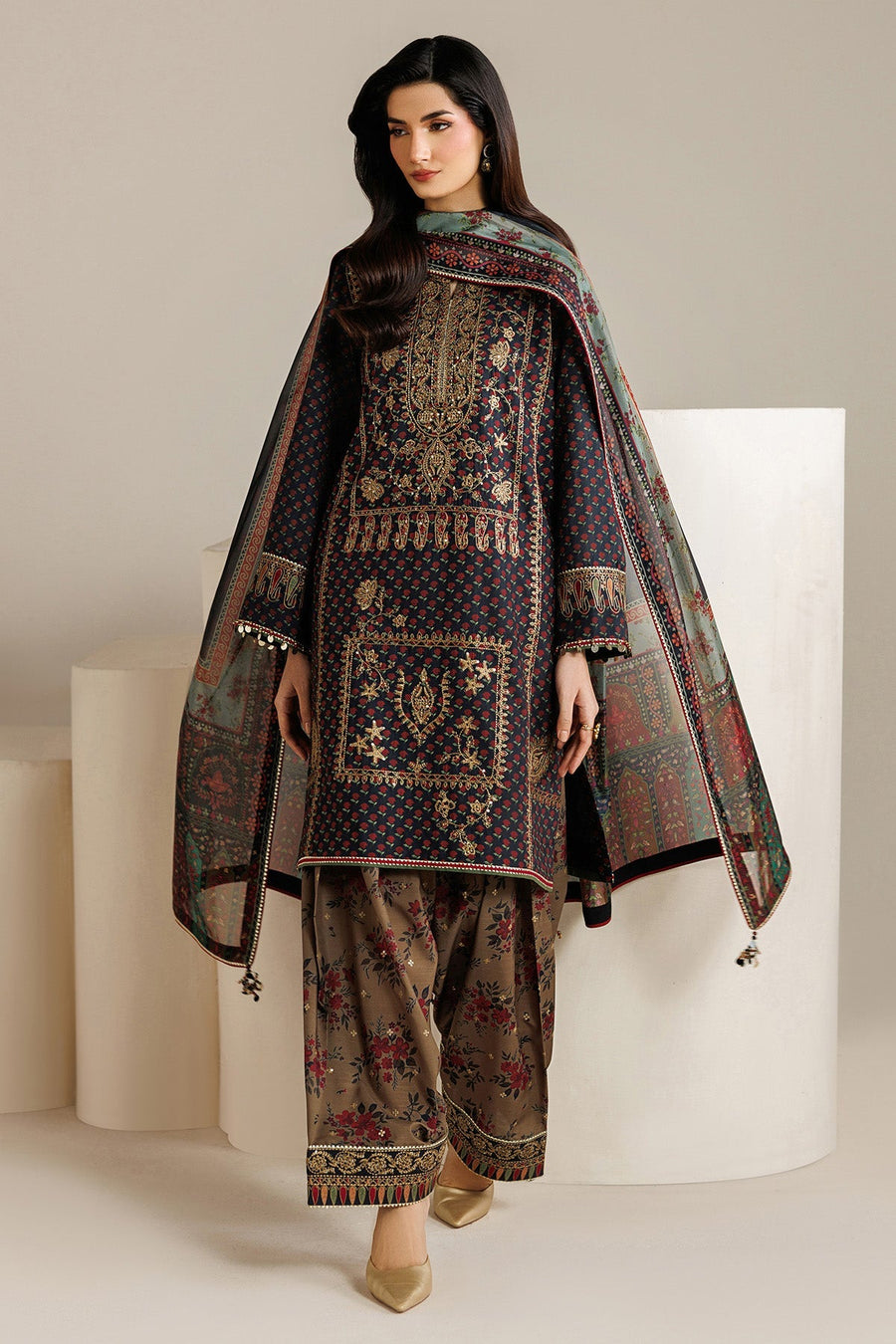 Front view of model in navy embroidered shirt and beige floral wide-leg pants with matching dupatta draped over shoulders