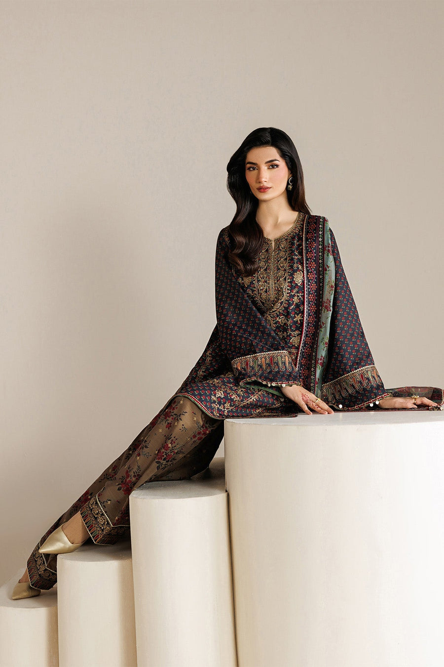 Side angled view highlighting embroidery and fabric texture of navy shirt and floral printed trousers