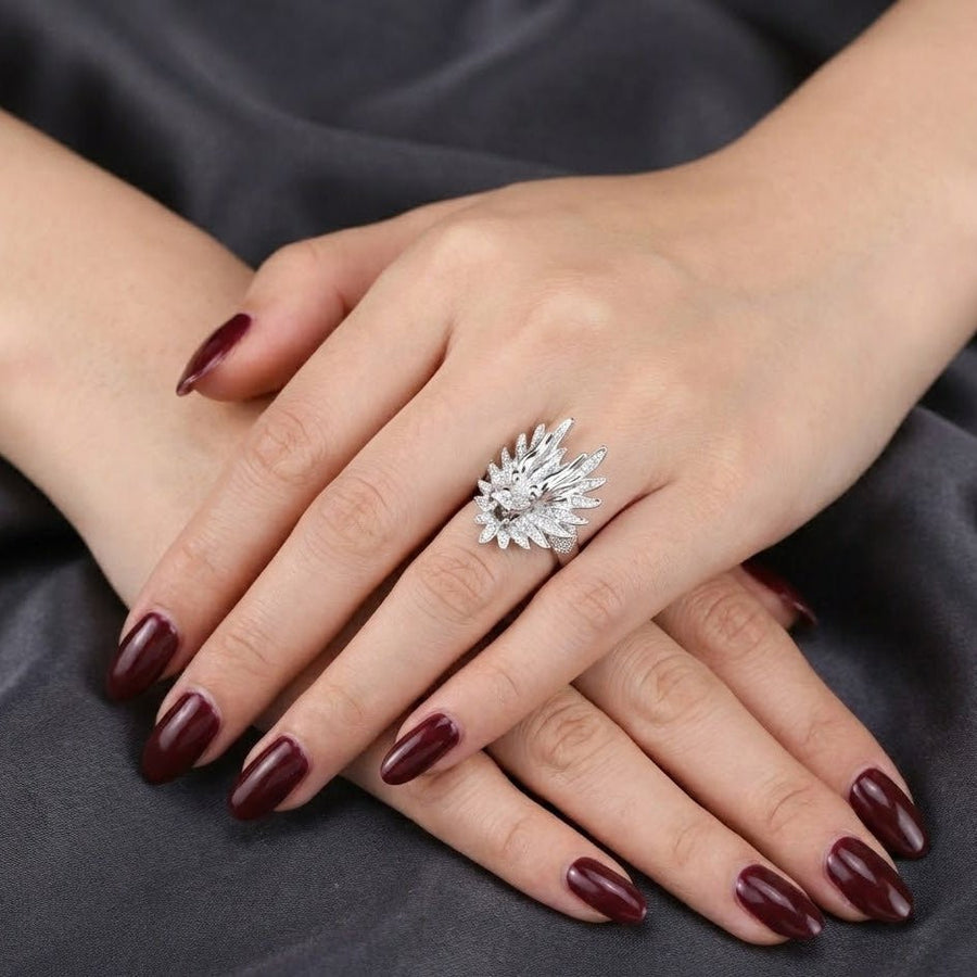 Female model wearing silver dragon head ring on finger, paired with dark nail polish and black fabric