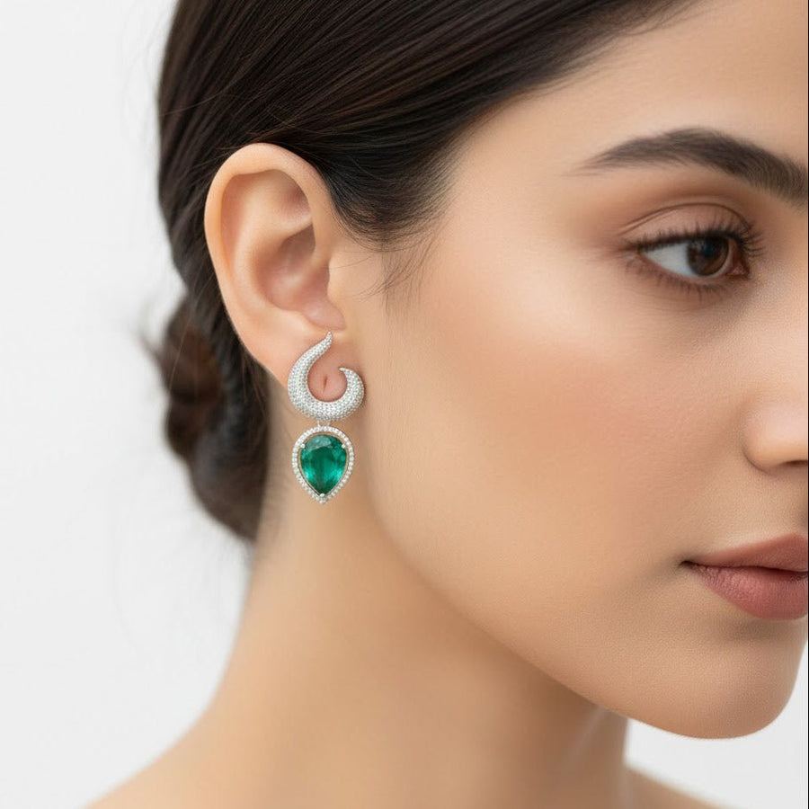 Close-up of woman wearing silver-plated earrings with clear teardrop gemstones