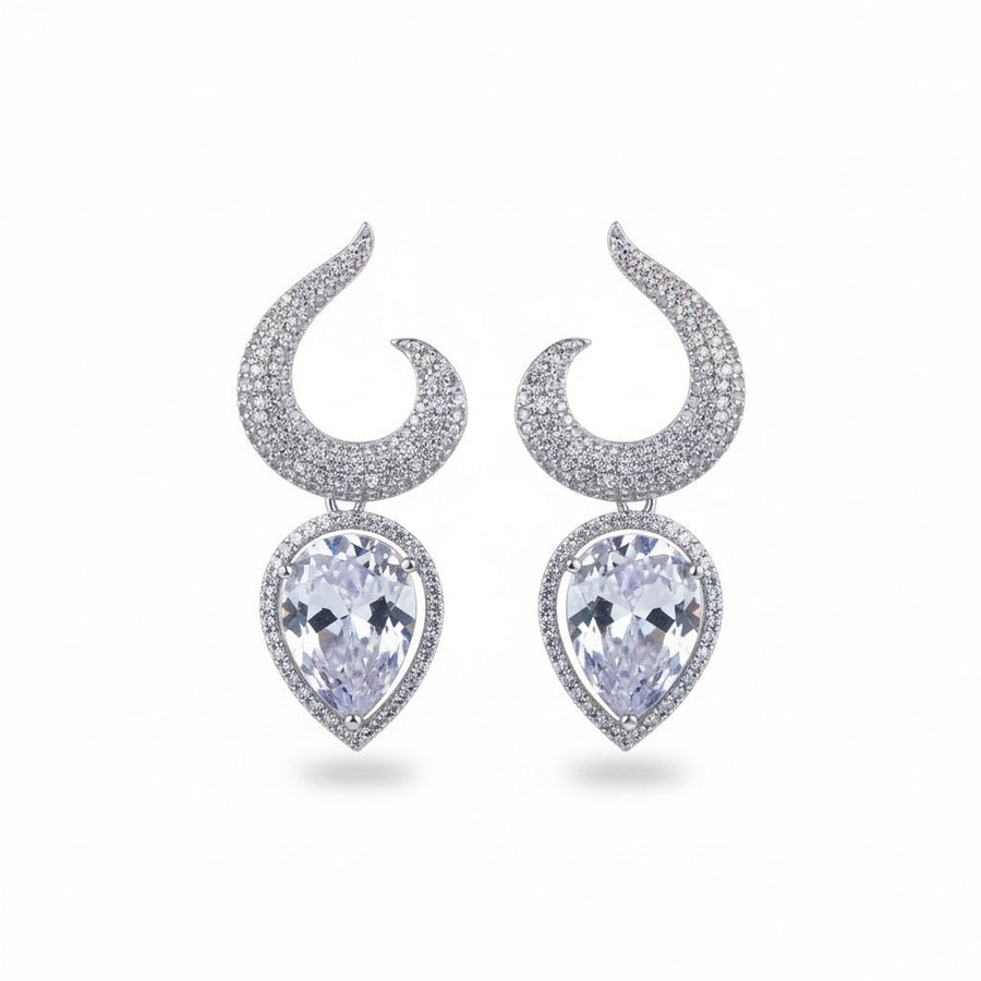 Pair of silver-plated earrings with clear teardrop gemstones displayed on white background