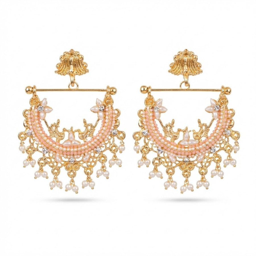 Close up of peach stone and pearl jhumka earrings on white background