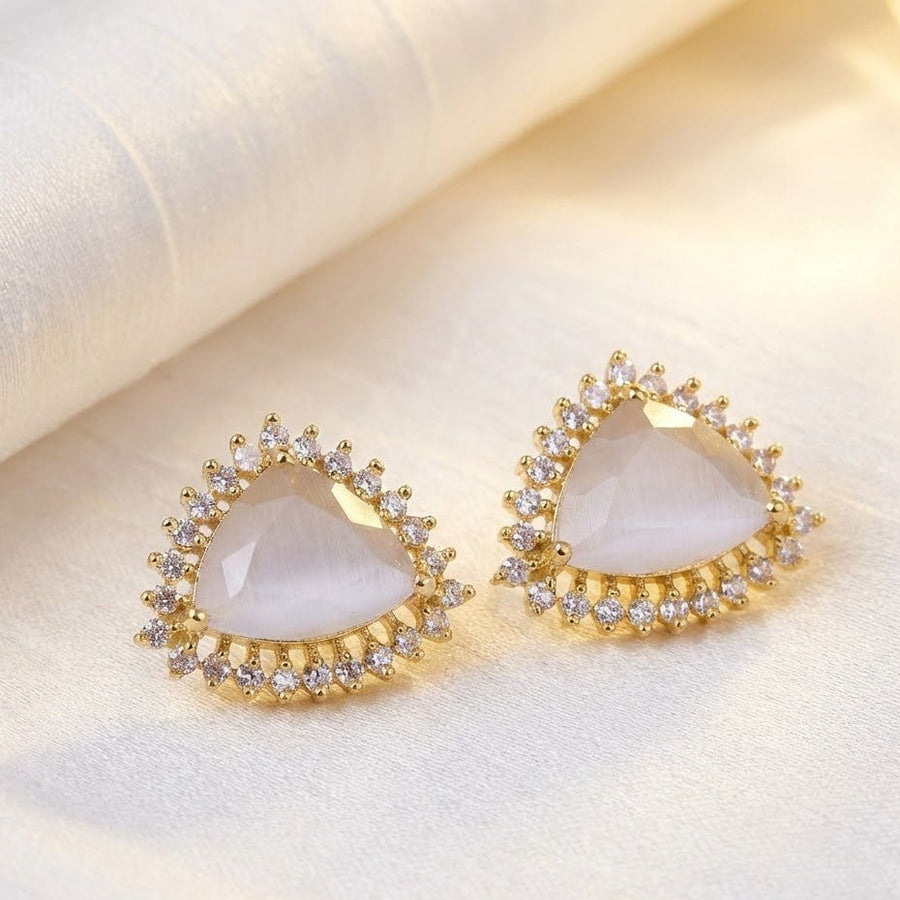 Close-up of women wearing milky white trillion cut gemstone halo stud earrings with modest formal wear