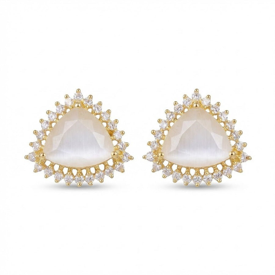 Milky white gemstone trillion cut halo stud earrings on black textured surface