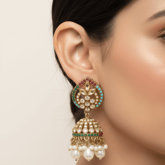 Woman wearing Majesty Pearl Drop earring showcasing detailed floral design with stones and dangling pearls