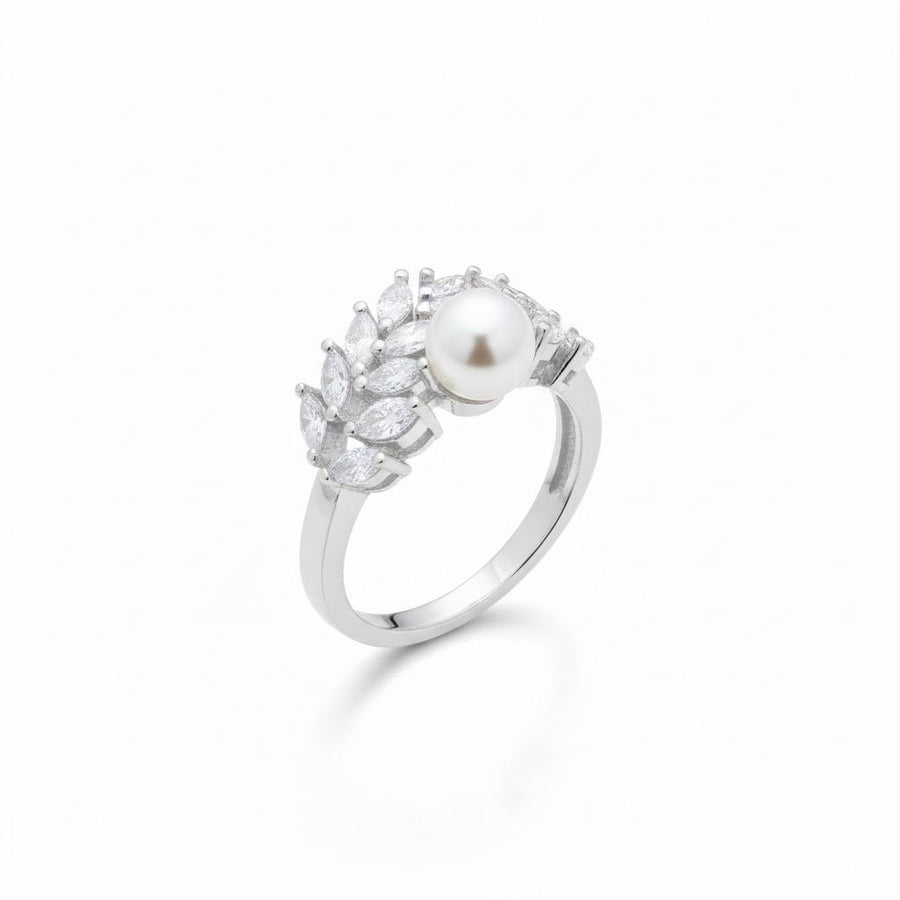 Silver band ring showcasing a luminous Akoya pearl and clustered zirconia stones in an elegant leaf design, displayed on white reflective surface.