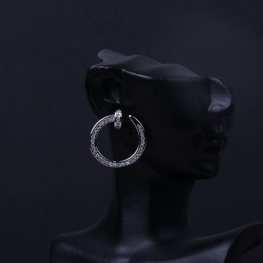Gold-tone rhinestone circle hoop earring displayed on a black mannequin ear