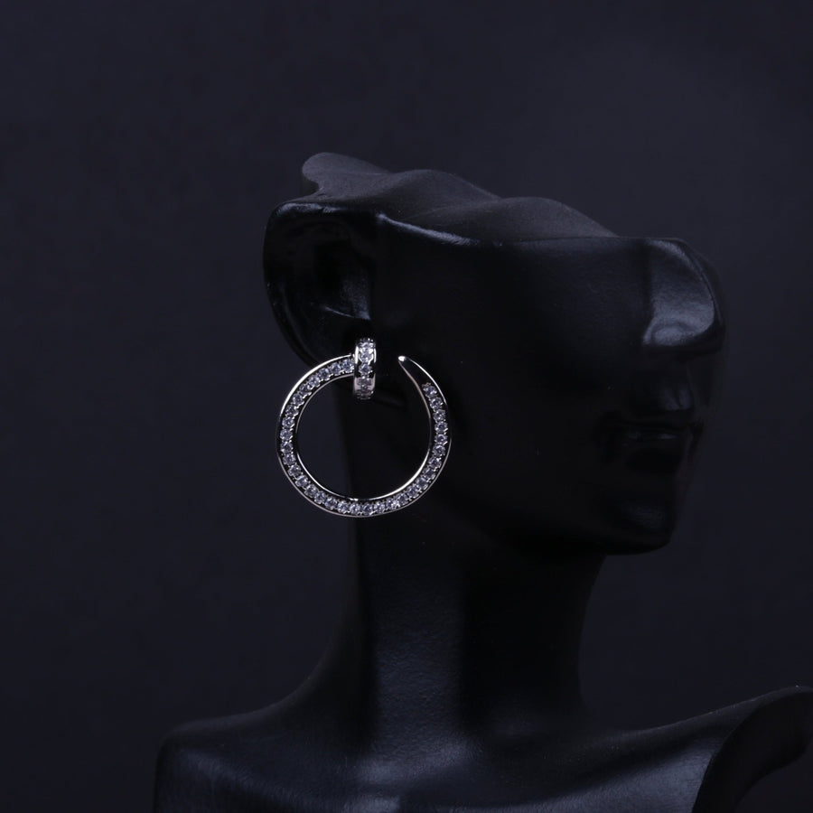 Gold-tone rhinestone circle hoop earring displayed on a black mannequin ear
