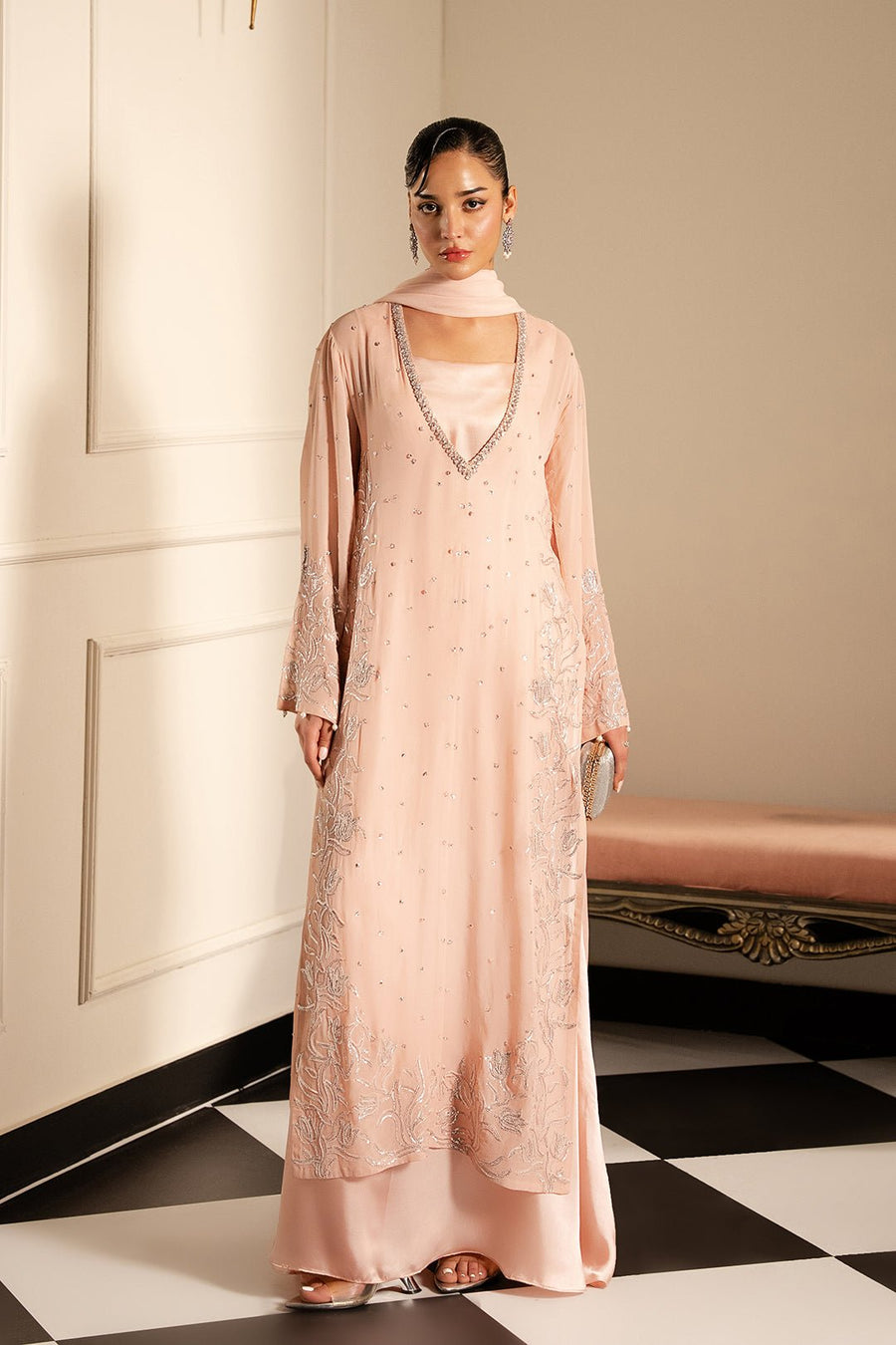 Full-length view of elegant blush pink formal dress with chiffon embroidery and silk underdress worn by model