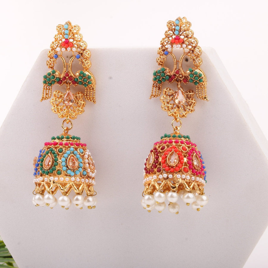 Pair of intricate multicolor jhumka earrings displayed on a white hexagonal stand highlighting vibrant beads and pearls