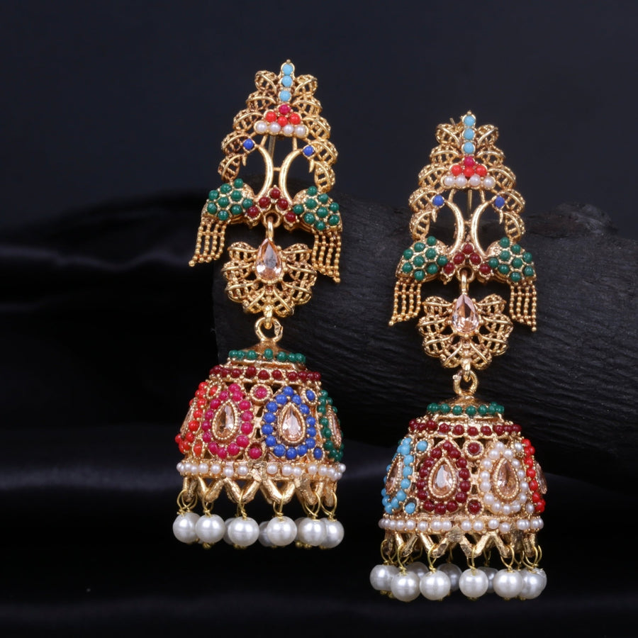 Close-up of elegant gold-tone jhumka earrings adorned with multicolor beads and pearl danglers against a dark background